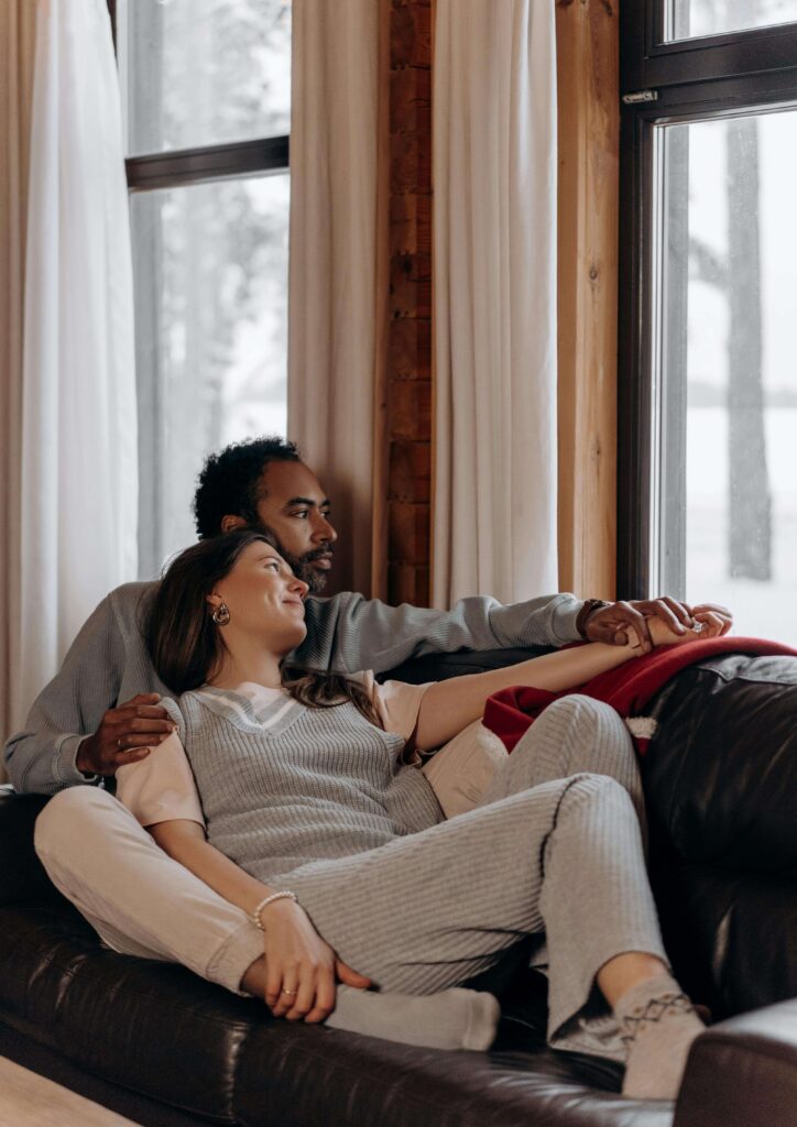 Happy interracial couple | intercultural couples therapy | couples counseling hermosa beach | emotionally focused couples therapy in hermosa beach, ca | Hermosa Beach CA 90277 | 90503 | South Bay CA 90226 | 90248 A happy interracial couple sitting on a sofa. Contact an EFT couples therapist in Hermosa Beach, CA, today to help your intercultural relationship thrive. Learn about the benefits you may gain from multicultural couples therapy.
