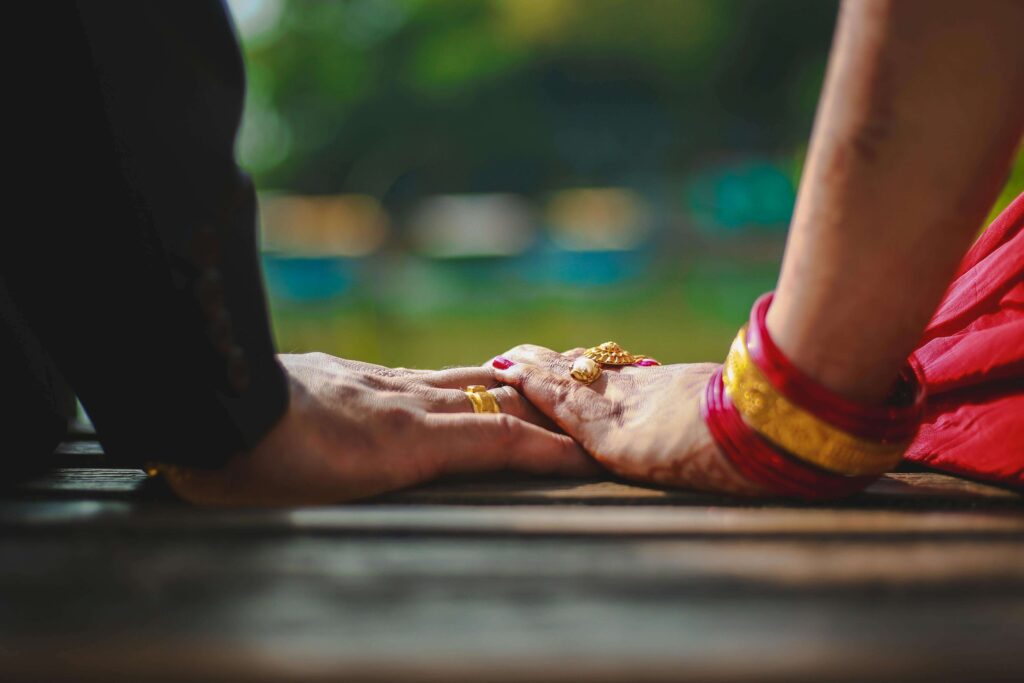 Intercultural couple sitting together and holding hands. With multicultural couples therapy in Hermosa Beach, CA, you can build your relationship on a strong and lasting foundation. My approach to multicultural marriage counseling and relationship counseling can help you and your partner achieve open and honest communication.