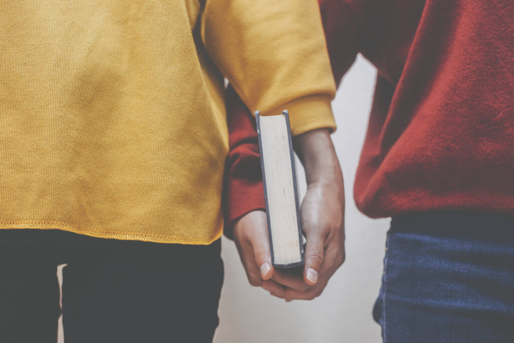 A close up of a couple holding the same book, representing a difference in religious beliefs. Learn more about the importance of cultural identity in Hermosa Beach, CA and how multicultural couple therapy can help address concerns. Search for a couples therapist in Hermosa Beach, CA today for more support.
