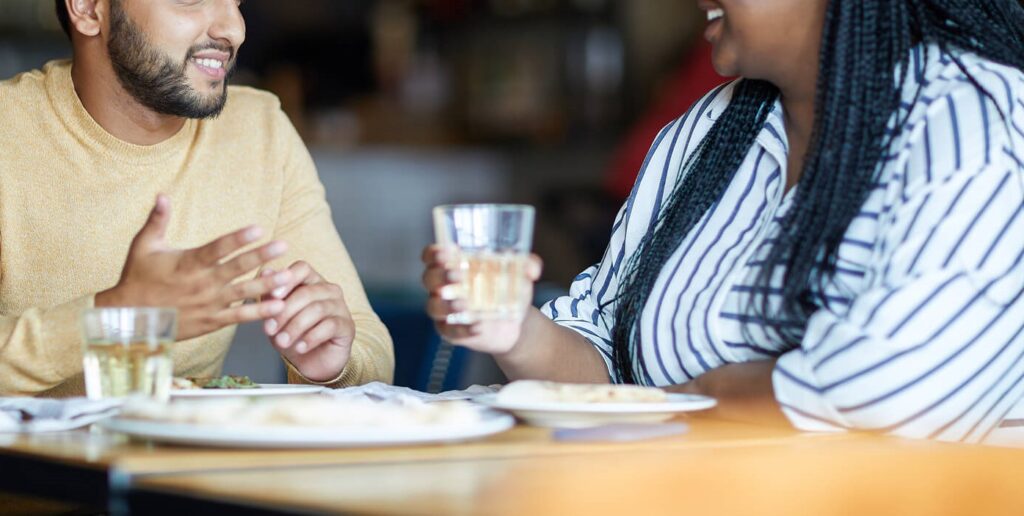 A couple smile while talking over breakfast and gesturing with their hands. Learn more about interracial couples counseling in Hermosa Beach area and how a couples therapist in Hermosa Beach, CA can offer support. Search for intercultural couples therapy for continuing help today.
